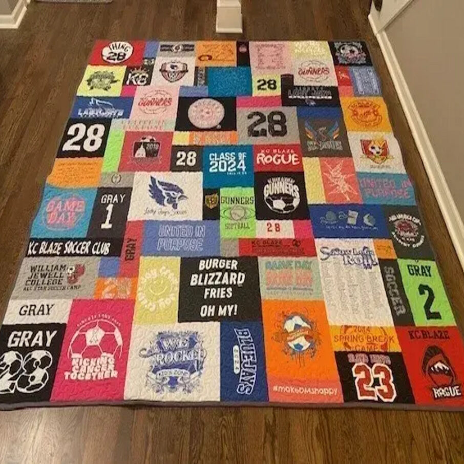 A quilt made of all the shirts from various sports.
